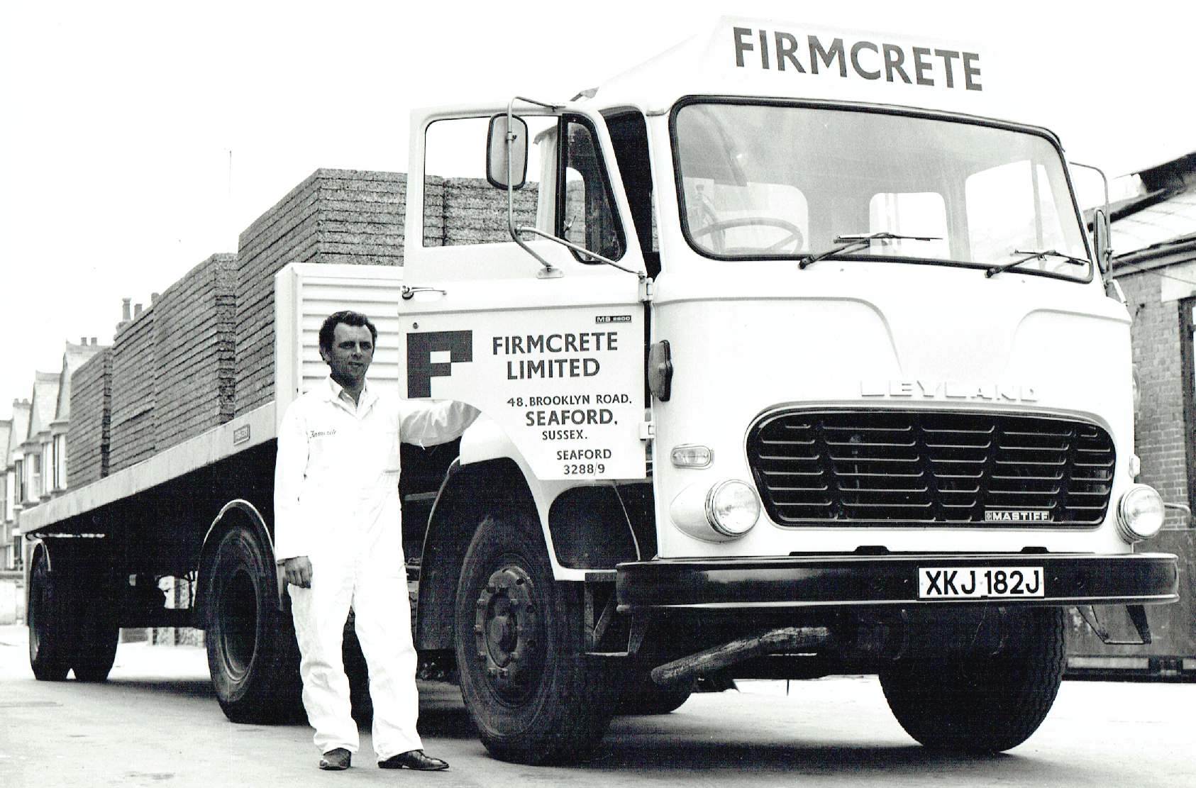 Alan Alsford beside a Leyland delivery truck in Seaford